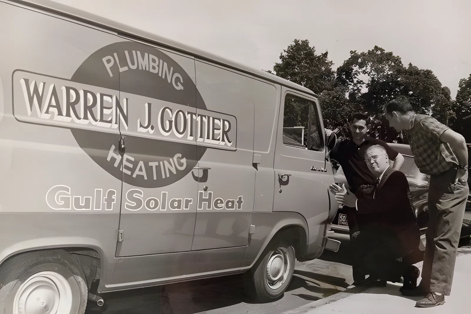 The original Warren J. Gottier Plumbing and Heating van with the founders, 1960s